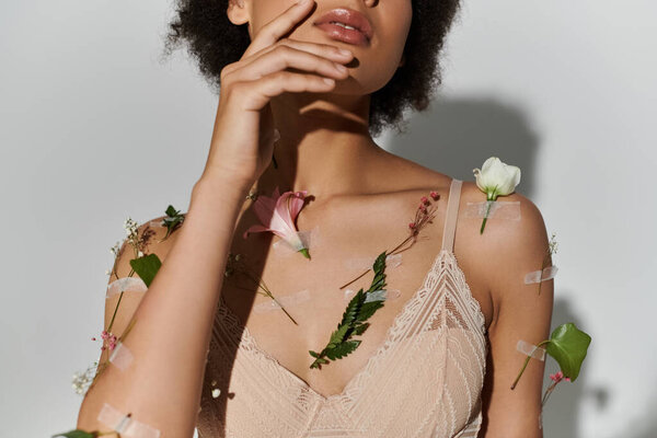 Pretty african american woman with beautiful plants on her body and underwear.
