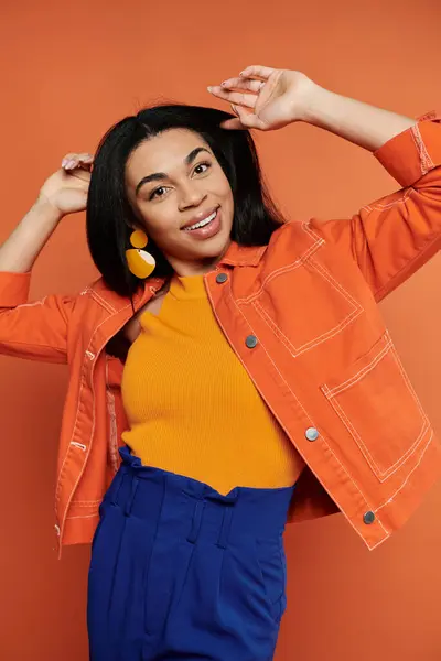 stock image A joyful woman expresses her style with bright colors and a playful pose.