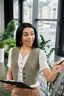 A cheerful woman shares insights while guiding a lively group discussion. clipart