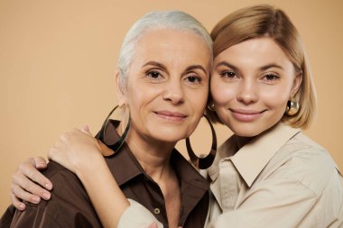 A lovely moment shared between a mature woman and her adult daughter. clipart