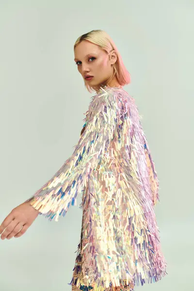 stock image A stylish young woman confidently showcases her holographic outfit.