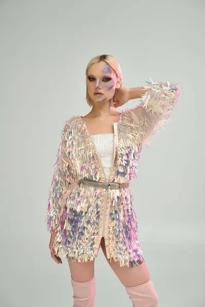 stock image A young woman showcases her chic style with shimmering holographic details.