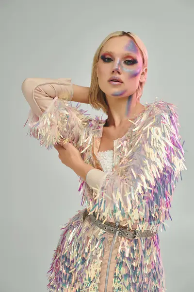 stock image A stylish young woman showcases vibrant holographic attire and captivating makeup.