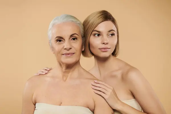 stock image A mature woman and her daughter share a tender moment together.