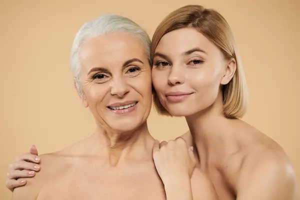 stock image A mature woman and her daughter share a warm, loving embrace.