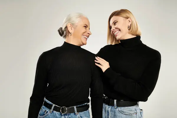 stock image A warm exchange of smiles between a mother and her adult daughter.