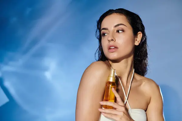 stock image Beautiful woman demonstrates her skincare regimen with a glowing product.