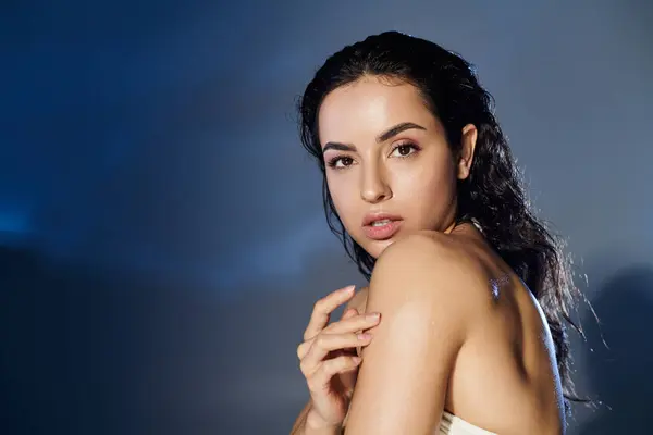 stock image A woman demonstrates her skincare routine on a colorful backdrop.