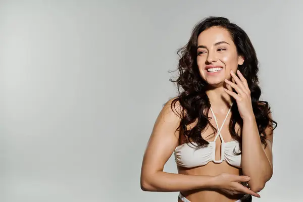 stock image Cheerful woman with dark long hair posing actively.