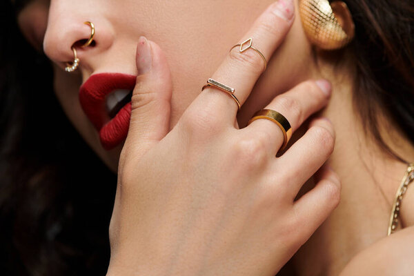 Яркий фон подчеркивает молодую женщину элегантные ювелирные изделия и уверенную позу.