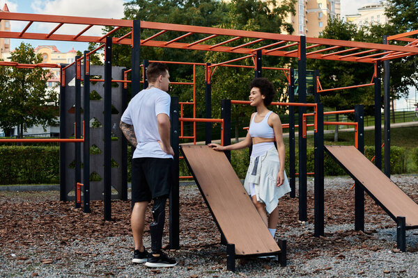 Two friends exercise outdoors, engaging in a motivating workout routine at a fitness park.