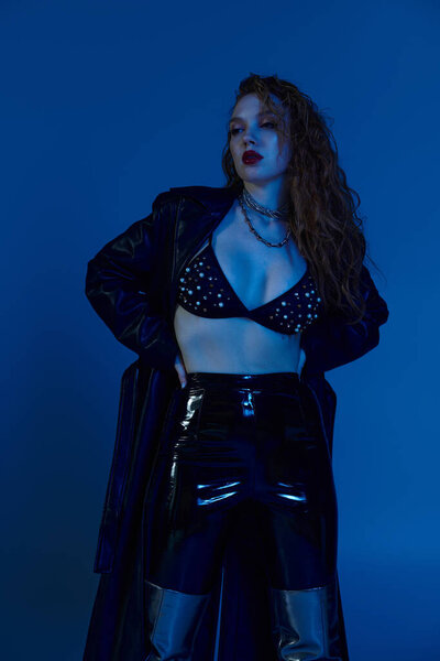 A confident woman showcases her unique style in bold, fashionable clothing.