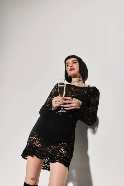 stock image A fashionable woman poses confidently holding a glass of champagne.