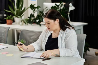 A professional woman writes notes and reviews her ideas in a chic office space filled with greenery. clipart