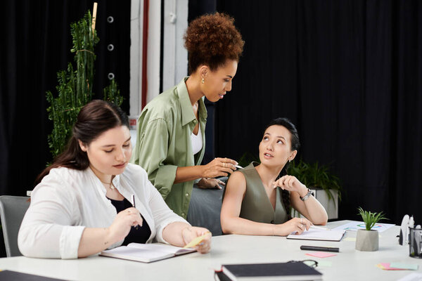 Three elegant businesswomen engage in lively discussion while working on a project together.