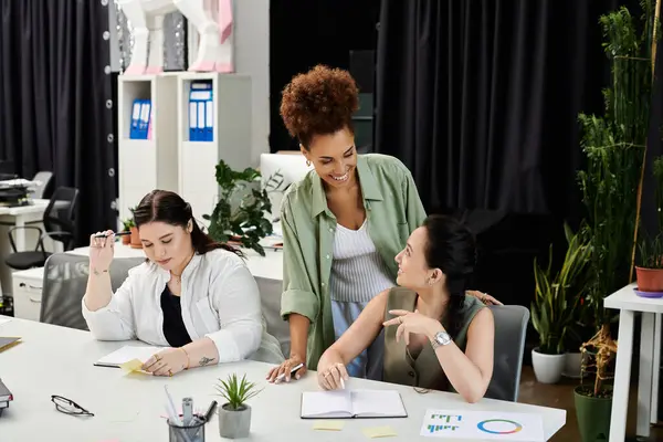 stock image Three professional women exchange ideas enthusiastically in a chic office.