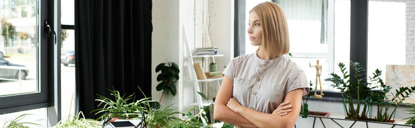 Young professional in a vibrant office space filled with plants.