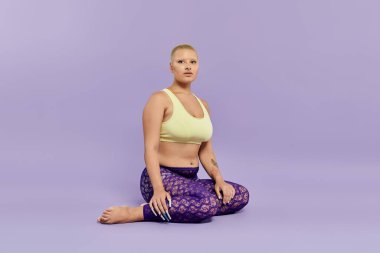 A bald woman in a yellow top and colorful leggings exudes confidence in a serene pose. clipart