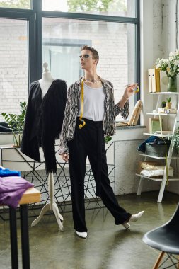 Modayı takip eden bir birey, şık stüdyo alanlarında eşsiz moda eserleri tasarlarken yaratıcılığını ifade eder..