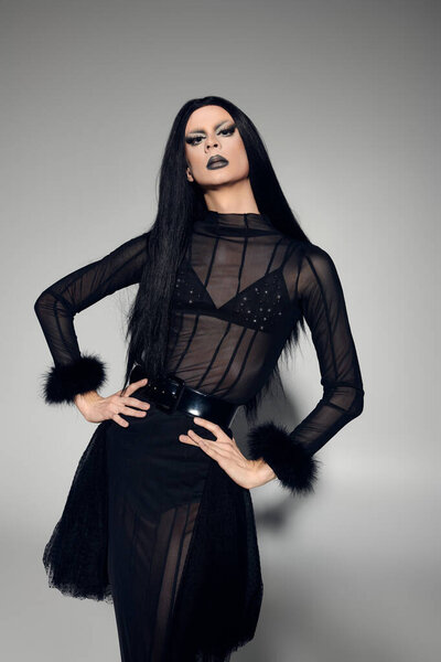 A captivating drag queen embraces gender fluidity in a bold black outfit, exuding confidence and style.