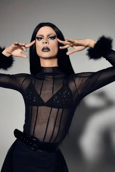 stock image The fashionable drag queen showcases their fierce style and confident presence in a stunning black ensemble.