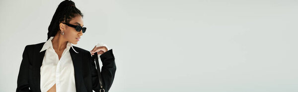 A confident woman in fashionable attire poses gracefully, highlighting her unique style.