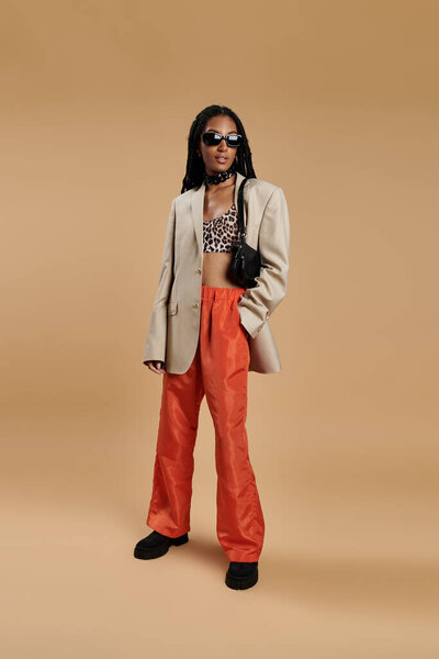 A young woman exudes confidence in a trendy ensemble, showcasing her unique style.