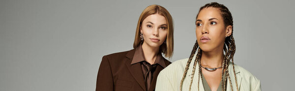 A beautiful lesbian couple enjoys each others company surrounded by vibrant autumn colors.