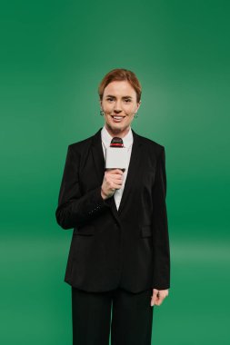 The TV presenter holds a microphone and smiles warmly, ready to engage with the audience clipart