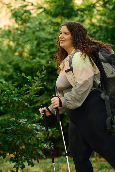 A joyful plus size woman walks through a vibrant nature forest, enjoying her outdoor adventure.