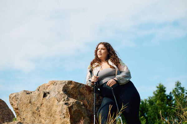 A beautiful plus size woman stands confidently in a field, embracing natures tranquility.