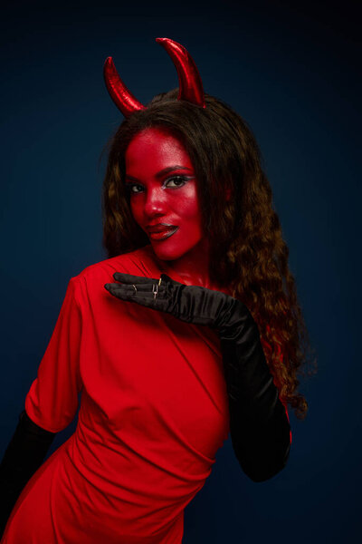This captivating character wears a vibrant red costume, exuding festive charm for Halloween.