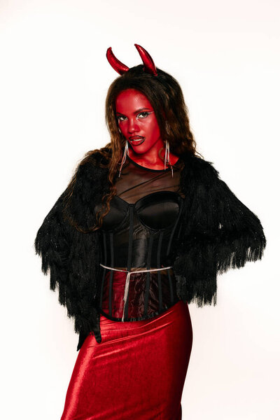 A stunning woman showcases her Halloween costume with confidence, celebrating the spooky season.