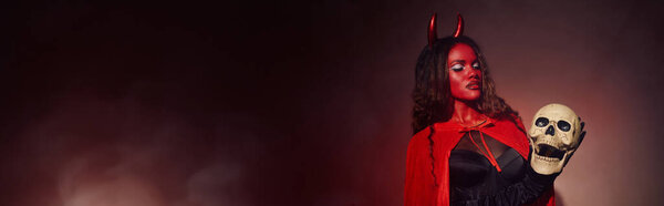 Feeling the Halloween spirit, a captivating woman in a devilish costume showcases her eerie charm.