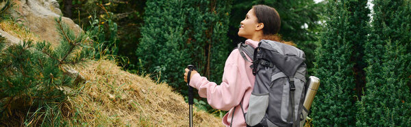 Exploring a colorful autumn forest, a young woman enjoys an invigorating hike surrounded by nature.
