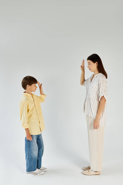 A mother supports her son with hearing impairment in a heartfelt interaction.