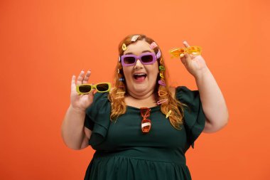 A joyful plus size woman dances in vibrant sunglasses, radiating fun in a bright scene. clipart