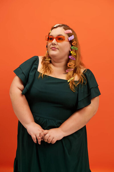 A confident plus size woman shines in her unique style and colorful accessories.