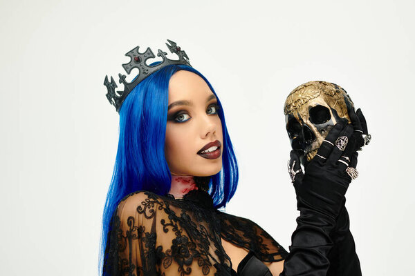 This captivating young woman showcases her Halloween spirit with a striking costume and skull.