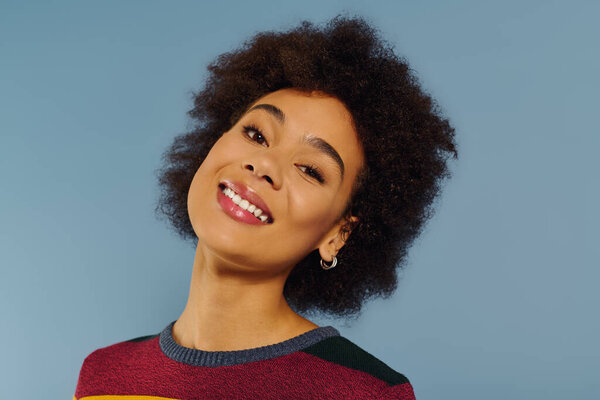 A young woman radiates happiness with a bright smile, showcasing her emotional spirit beautifully.