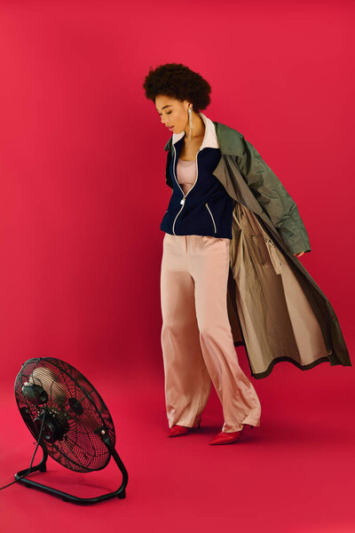 A young woman expresses deep emotions while styled in trendy attire, standing gracefully.