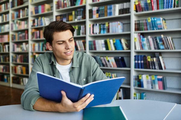 A focused student engages deeply with his studies, surrounded by numerous books in a cozy library.