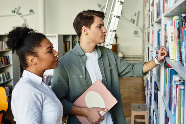 A dedicated educator supports her eager student while exploring diverse books in the library.