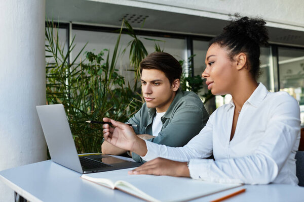 Student and his teacher  collaborating at a study table in a vibrant library environment.