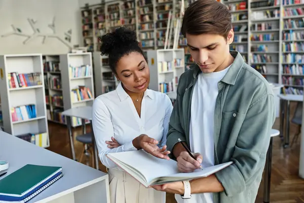 stock image A dedicated teacher supports her young student as they engage in educational activities together.