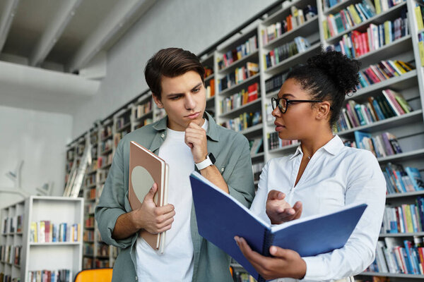 A dedicated teacher guides her eager student in a bustling library, sparking curiosity.