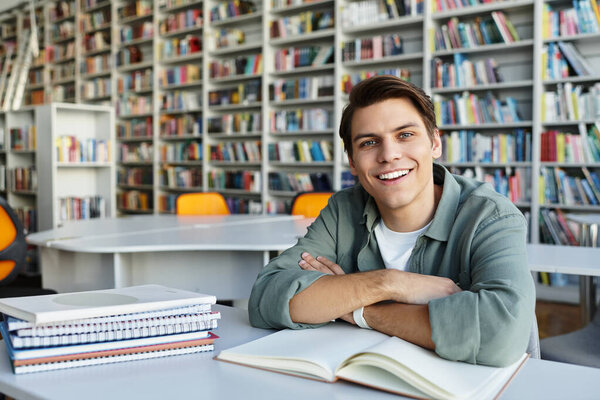 Merry handsome student in casual attire at school, studying hard.