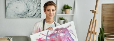 Evde, genç bir kadın doğal makyajla renkli bir resim çizerken yaratıcılığını ifade ediyor..