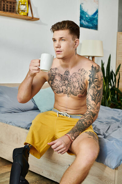 A young man with a prosthetic leg savors a cup of coffee in a stylish, relaxed setting.