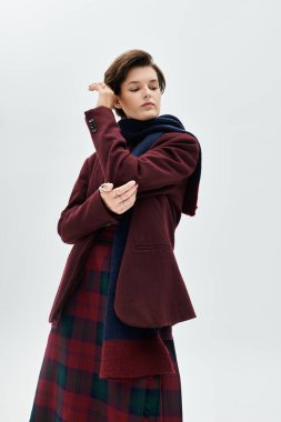 Göz kamaştırıcı bir kadın, rahat bir kış elbisesi giyer, sakin bir atmosferde zarafet saçar..